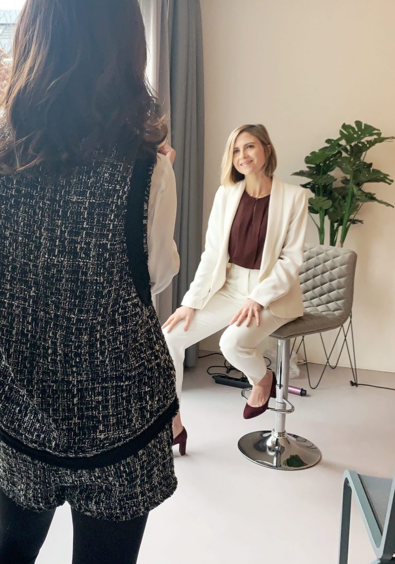 Professional woman in an elegant white business suit during a personal styling session with Lu Cai